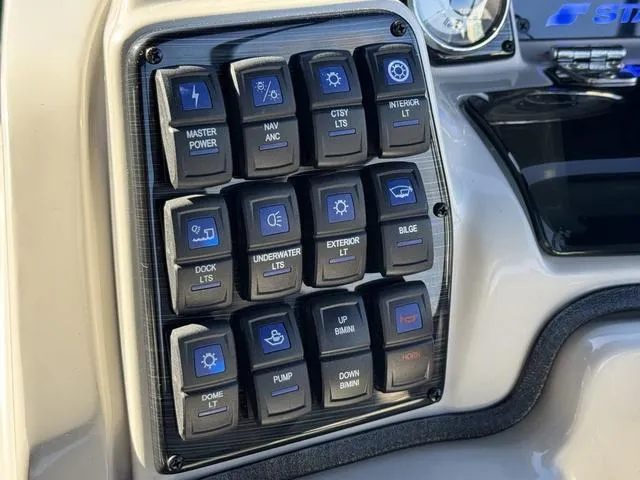 Slide: The Image of Control panel of 2025 Starcraft CX 23 RL boat with labeled switches. - 24