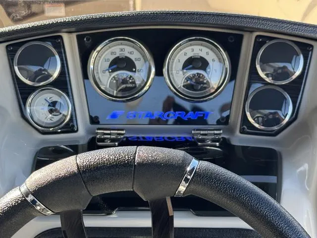 Slide: The Image of Dashboard of 2025 Starcraft CX 23 RL boat with gauges and steering wheel. - 25