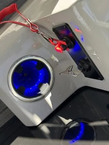 Slide: The Image of 2025 Starcraft CX 23 RL boat dashboard with illuminated cup holder and control panel. - 27