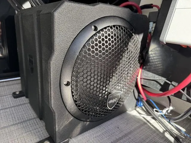 Slide: The Image of Speaker system in a 2025 Starcraft CX 23 RL boat, featuring a protective grille. - 32