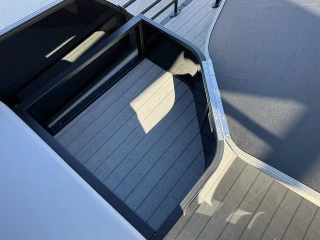 Slide: The Image of 2025 Starcraft CX 23 RL boat interior with sleek, modern design and spacious deck area. - 36