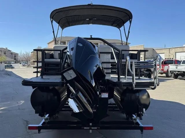 Slide: The Image of 2025 Starcraft CX 23 RL pontoon boat with spacious seating at a boat show. - 4