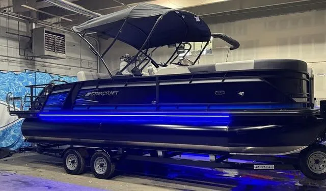 Slide: The Image of 2025 Starcraft CX 23 RL boat interior with cushioned seating and modern design. - 8