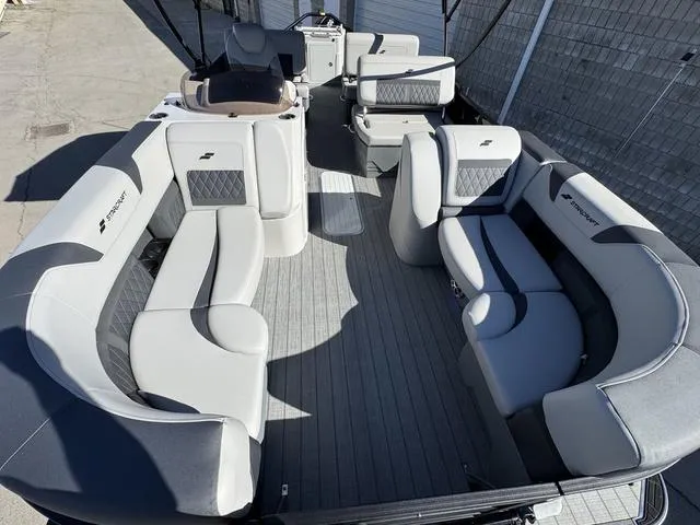 Slide: The Image of Captain's seat and steering wheel of 2025 Starcraft CX 23 RL boat interior. - 9