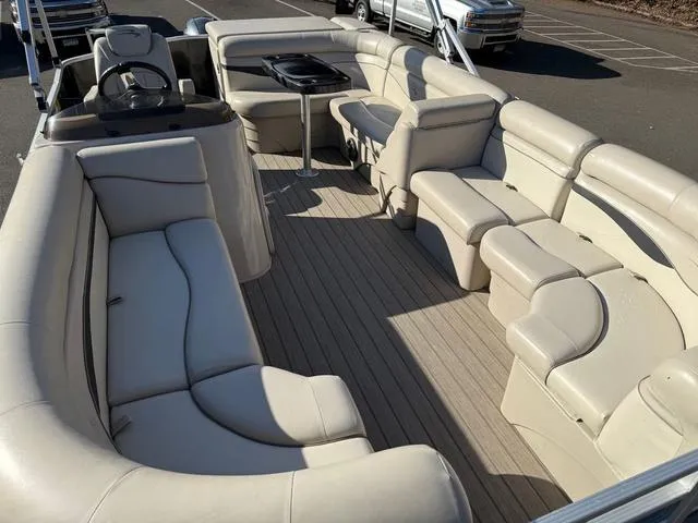 Slide: The Image of 2017 Bennington 20SLMX pontoon boat with spacious beige seating and modern interior design. - 11