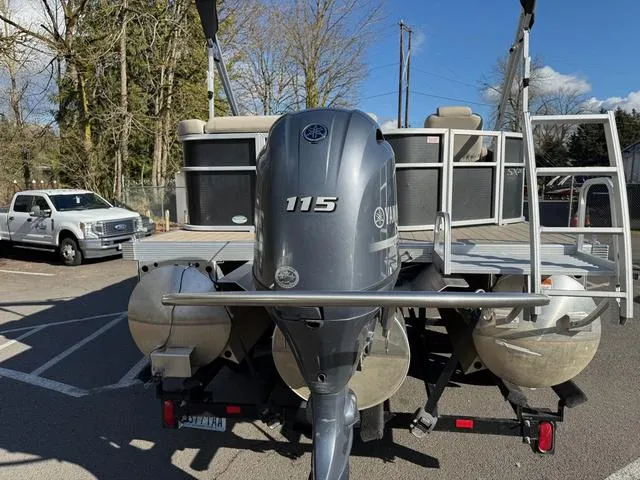 Slide: The Image of 2017 Bennington 20SLMX pontoon boat with Yamaha 115 outboard motor, parked outdoors. - 3