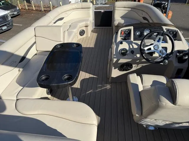 Slide: The Image of 2017 Bennington 20SLMX pontoon boat interior with beige seating and steering console. - 5