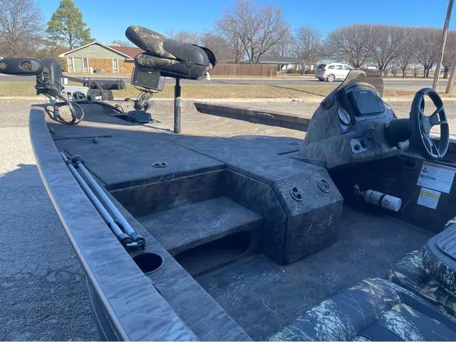 Slide: The Image of 2022 G3 Sportsman 1710 boat interior with steering wheel and fishing equipment. - 6