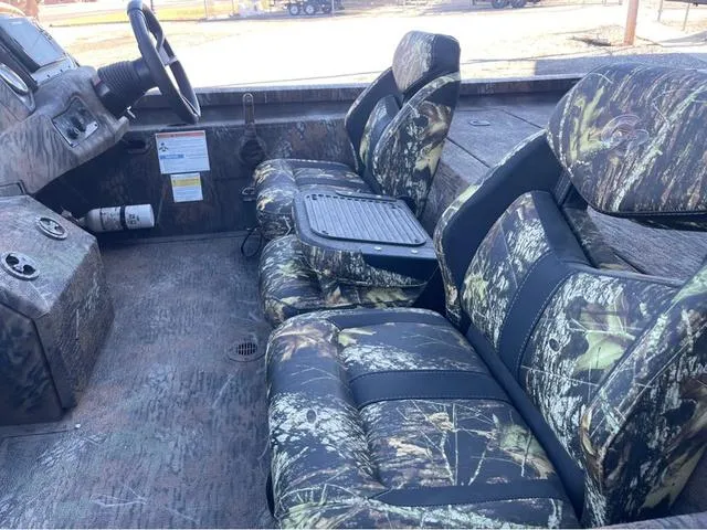 Slide: The Image of 2022 G3 Sportsman 1710 boat interior with camouflage seats and steering wheel. - 7