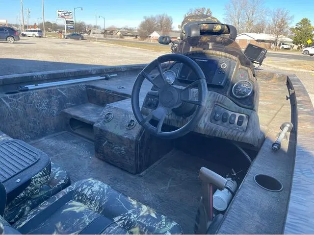 Slide: The Image of 2022 G3 Sportsman 1710 boat interior with camo design and steering console. - 9