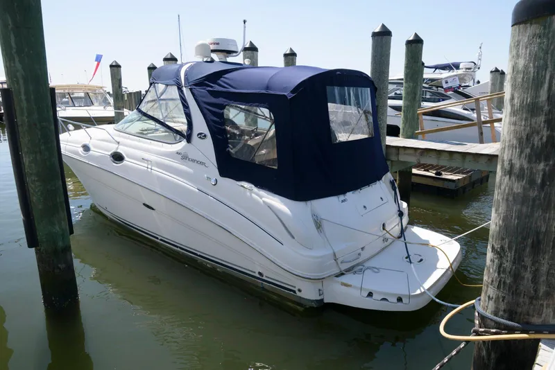 The Image of 2005 Sea Ray 280 Sundancer docked with blue canopy in marina. - 0
