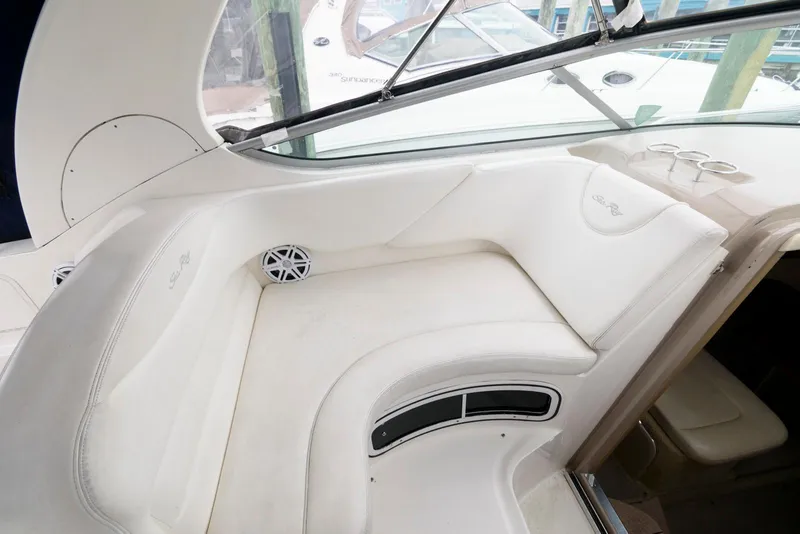 Slide: The Image of 2005 Sea Ray 280 Sundancer interior with white seating and speaker. - 10