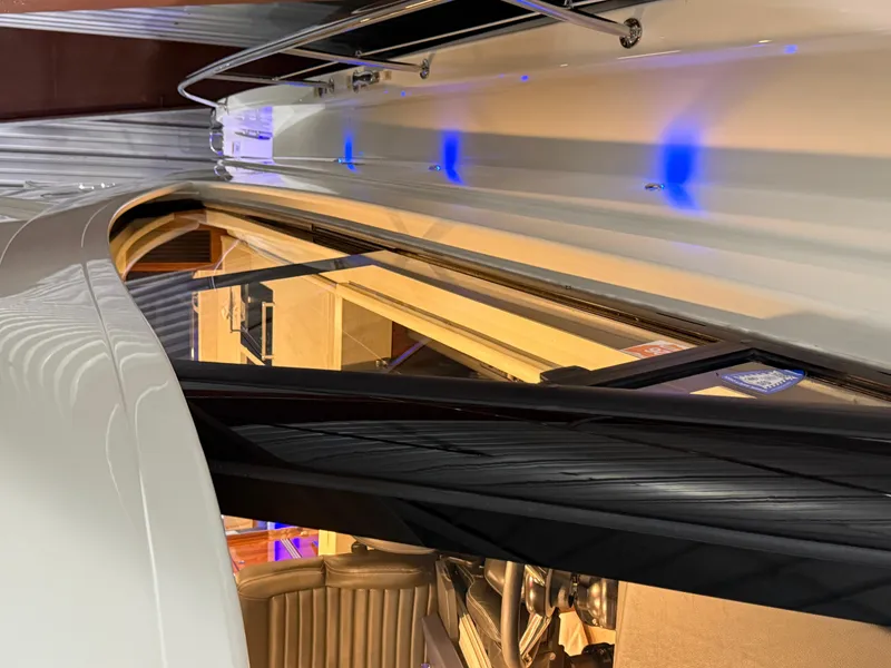 Slide: The Image of 2019 Riviera 4800 Sport Yacht interior with sleek design and ambient blue lighting. - 10