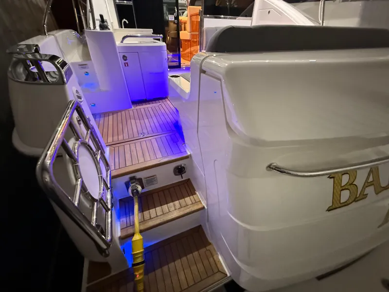 Slide: The Image of 2019 Riviera 4800 Sport Yacht with illuminated deck and sleek design. - 16