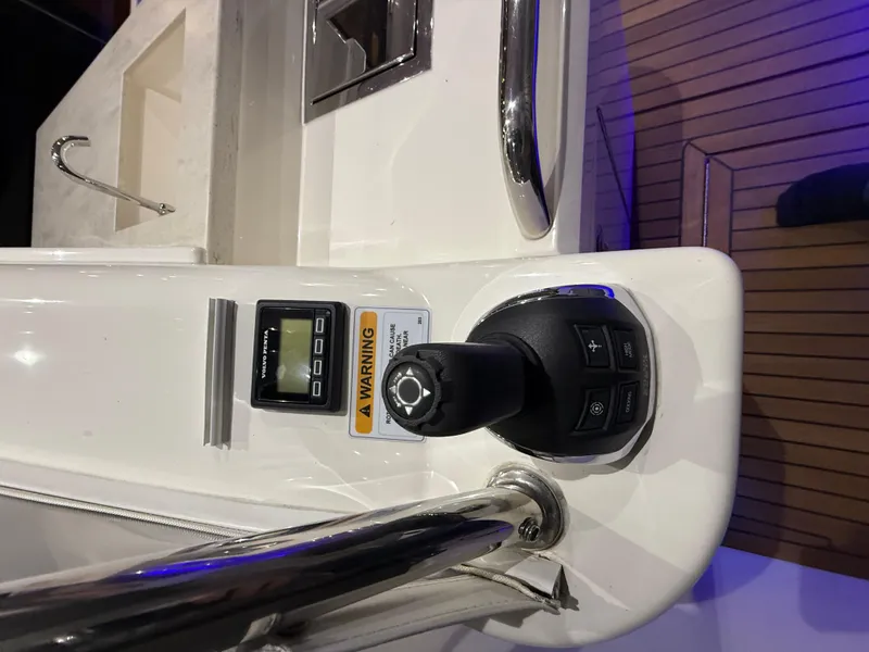 Slide: The Image of Control panel of a 2019 Riviera 4800 Sport Yacht with joystick and warning label. - 25