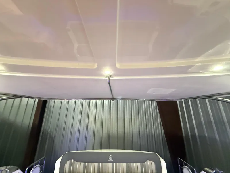 Slide: The Image of Interior view of 2019 Riviera 4800 Sport Yacht, featuring sleek ceiling design and seating. - 29
