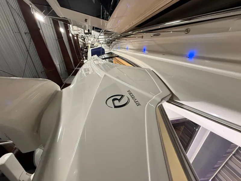 Slide: The Image of 2019 Riviera 4800 Sport Yacht in a showroom, showcasing sleek design and modern features. - 3
