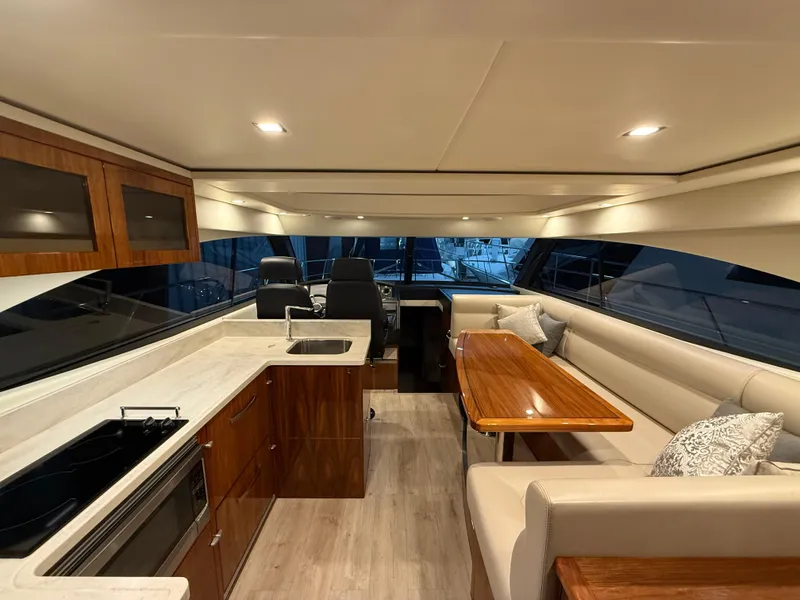 Slide: The Image of Luxurious interior of 2019 Riviera 4800 Sport Yacht with modern kitchen and seating area. - 30