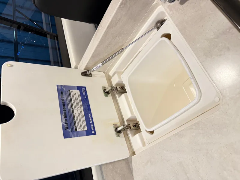 Slide: The Image of Waste management compartment on 2019 Riviera 4800 Sport Yacht, open lid showing interior. - 39