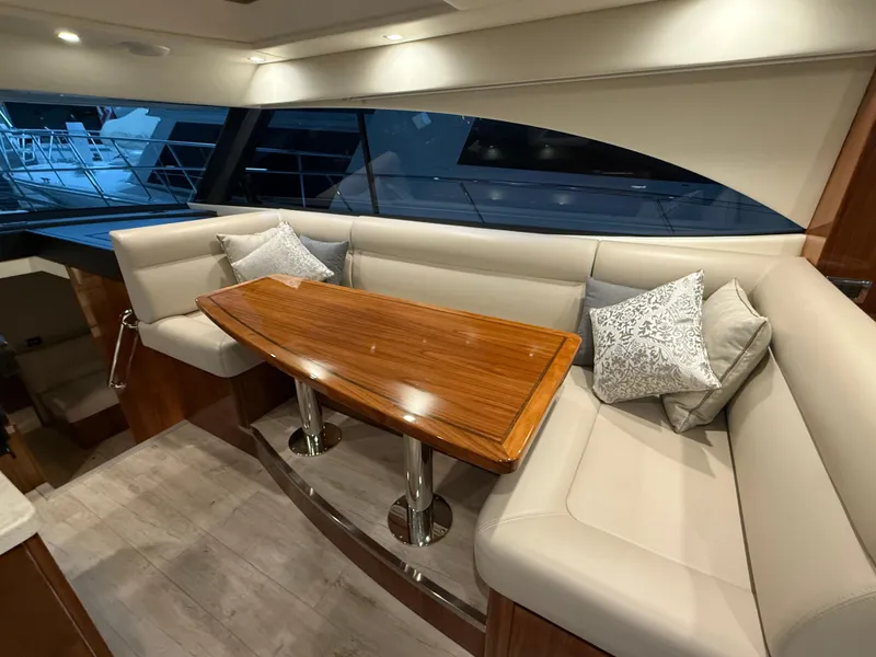 Slide: The Image of Luxurious interior of 2019 Riviera 4800 Sport Yacht with elegant seating and wooden table. - 40