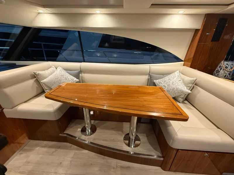 Slide: The Image of Luxurious interior of 2019 Riviera 4800 Sport Yacht with elegant seating and wooden table. - 41