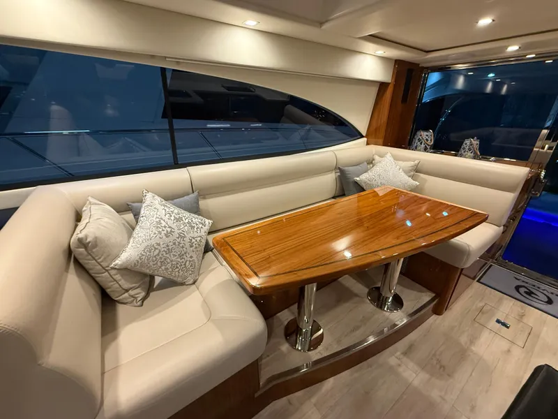 Slide: The Image of Luxurious interior of 2019 Riviera 4800 Sport Yacht with elegant seating and wooden table. - 42