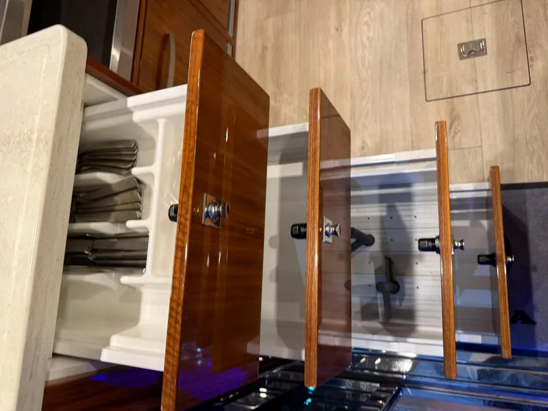 Slide: The Image of Open wooden drawers in a 2019 Riviera 4800 Sport Yacht kitchen. - 43
