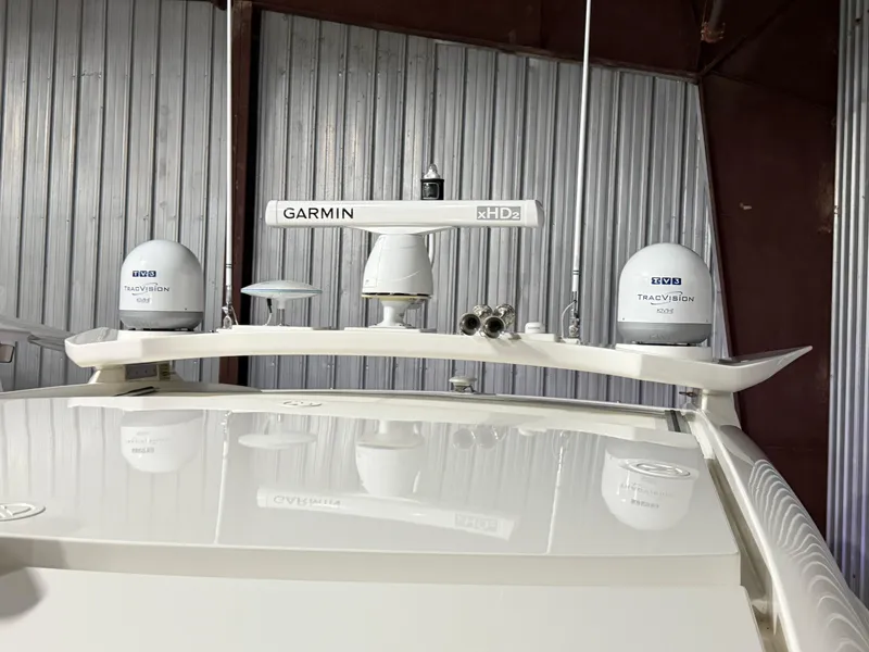 Slide: The Image of Riviera 4800 Sport Yacht 2019 with Garmin and TracVision equipment in a storage facility. - 6