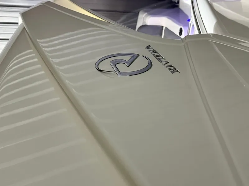Slide: The Image of Close-up of 2019 Riviera 4800 Sport Yacht logo on sleek beige surface. - 7