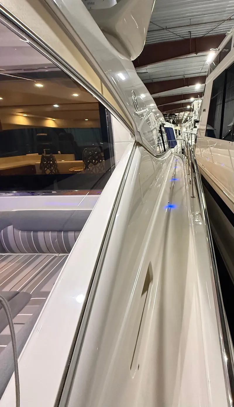 Slide: The Image of 2019 Riviera 4800 Sport Yacht interior view with sleek design and ambient lighting. - 9