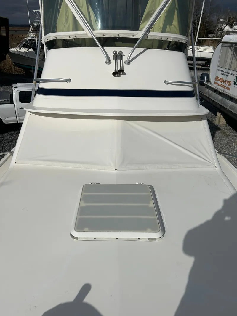 Slide: The Image of 1995 Blackfin 33 Convertible boat, front deck view with windshield and hatch. - 14