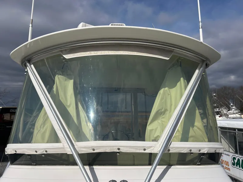 Slide: The Image of 1995 Blackfin 33 Convertible boat with enclosed cockpit and yellow curtains. - 15