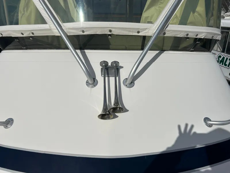 Slide: The Image of 1995 Blackfin 33 Convertible boat with dual air horns and windshield wipers. - 16