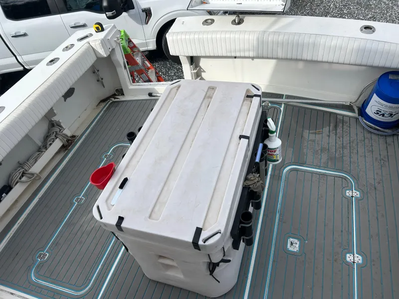 Slide: The Image of 1995 Blackfin 33 Convertible boat deck with cooler and fishing gear. - 18