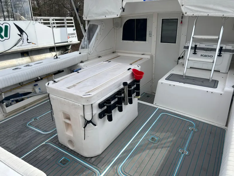 Slide: The Image of 1995 Blackfin 33 Convertible boat deck with fishing gear and cooler. - 19