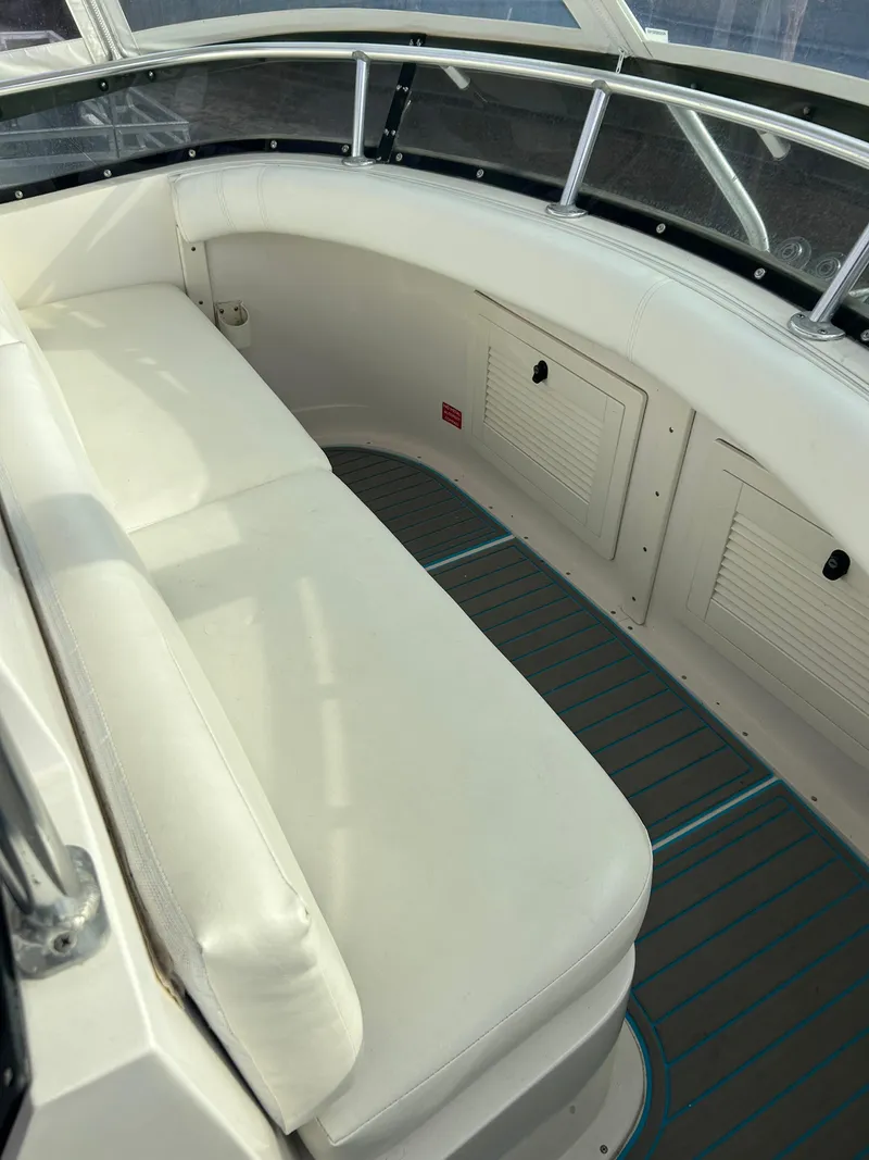 Slide: The Image of 1995 Blackfin 33 Convertible boat interior with white seating and storage compartments. - 24