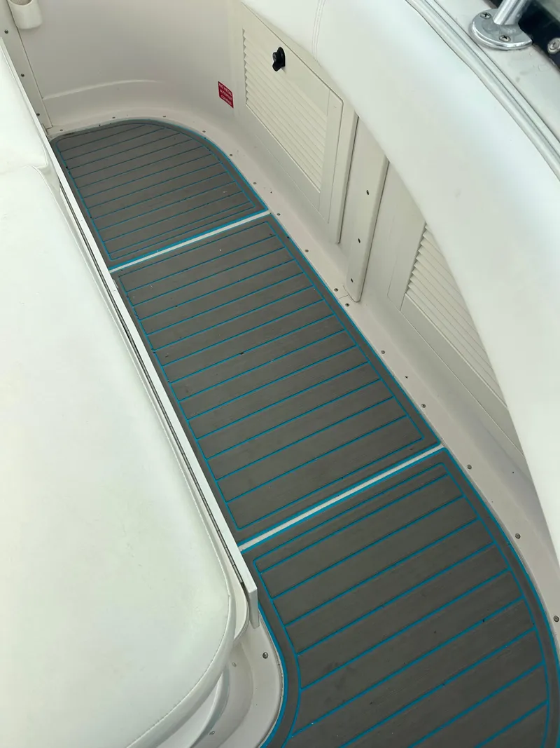 Slide: The Image of 1995 Blackfin 33 Convertible boat interior with gray and blue striped flooring. - 26