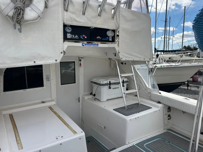 Slide: The Image of 1995 Blackfin 33 Convertible boat deck with storage and cooler. - 27