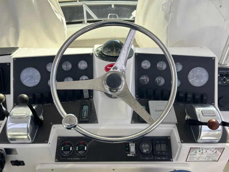 Slide: The Image of 1995 Blackfin 33 Convertible boat dashboard with steering wheel and control gauges. - 28