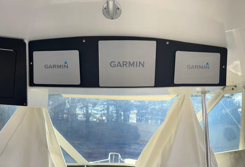 Slide: The Image of Garmin navigation panels inside a 1995 Blackfin 33 Convertible boat. - 30