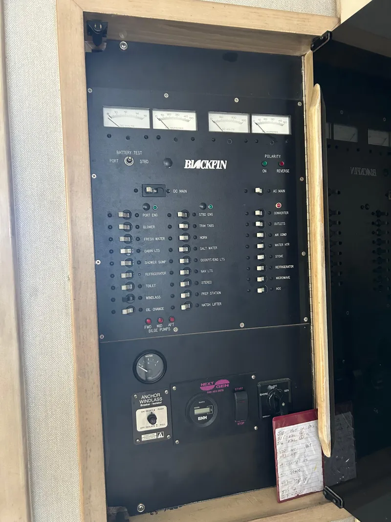 Slide: The Image of Electrical panel of a 1995 Blackfin 33 Convertible boat with gauges and switches. - 31