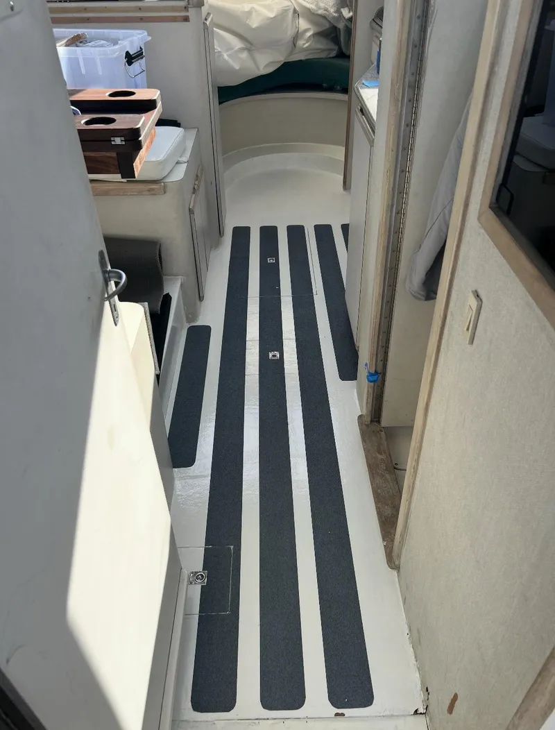 Slide: The Image of Interior view of a 1995 Blackfin 33 Convertible boat, featuring striped flooring. - 46
