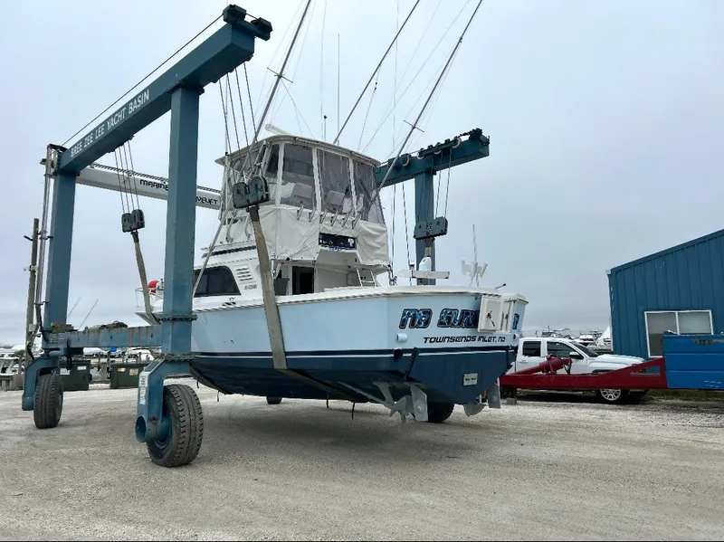 Slide: The Image of 1995 Blackfin 33 Convertible boat on a lift at a marina. - 48