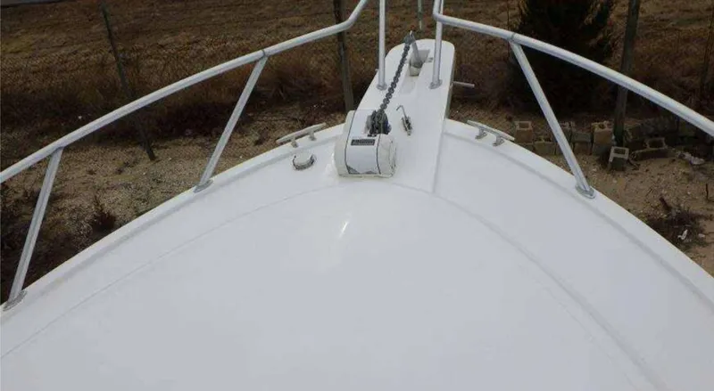 Slide: The Image of Bow view of 1995 Blackfin 33 Convertible boat, featuring white deck and railing. - 7