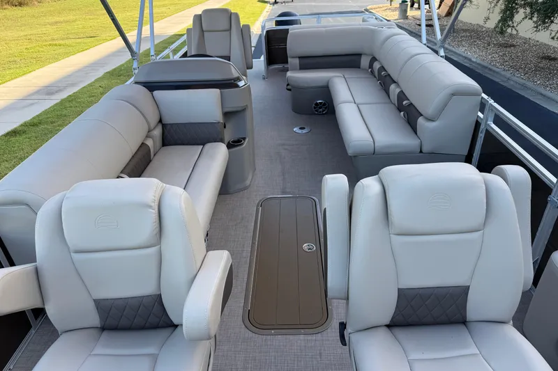 Slide: The Image of 2025 Sun Tracker Sportfish 24 XP3 pontoon boat interior with plush seating and modern design. - 3