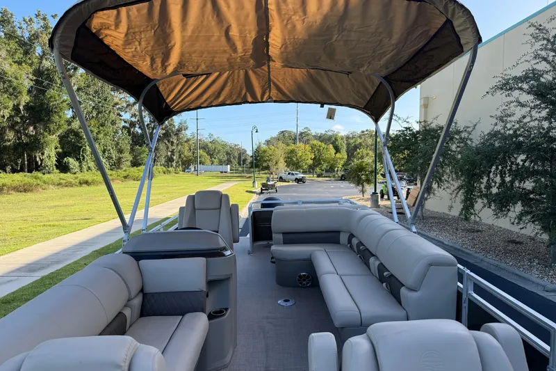 Slide: The Image of 2025 Sun Tracker Sportfish 24 XP3 pontoon boat with spacious seating and canopy. - 4