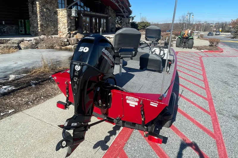 Slide: The Image of 2025 Tracker Bass Tracker Classic XL boat with Mercury 50 engine, parked outdoors. - 2