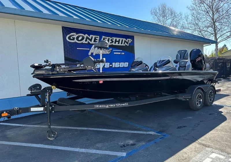 Slide: The Image of 2025 Ranger ALPHA 208 boat on trailer outside a fishing store. - 1