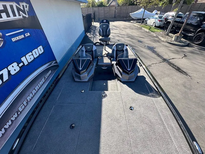 Slide: The Image of 2025 Ranger ALPHA 208 boat with dual seats and sleek design in a parking area. - 28