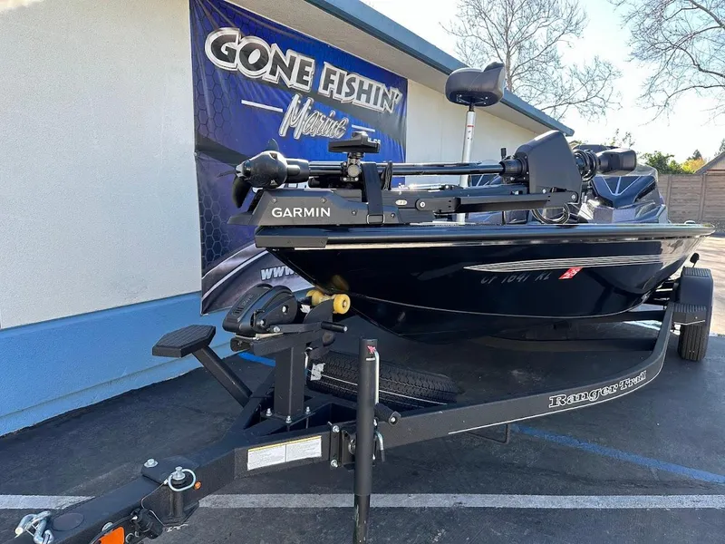 Slide: The Image of 2025 Ranger ALPHA 208 boat on trailer, Garmin equipment, "Gone Fishin'" banner in background. - 6